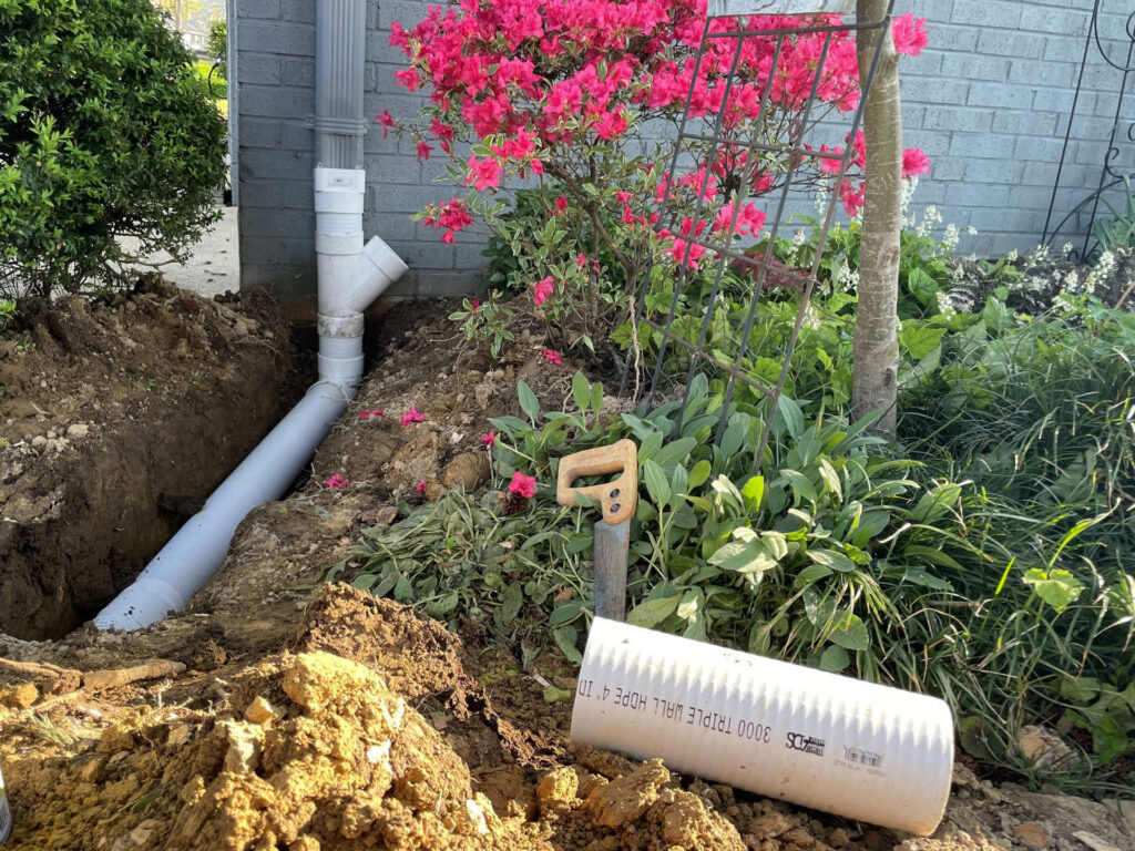 downspout extension under flower bed